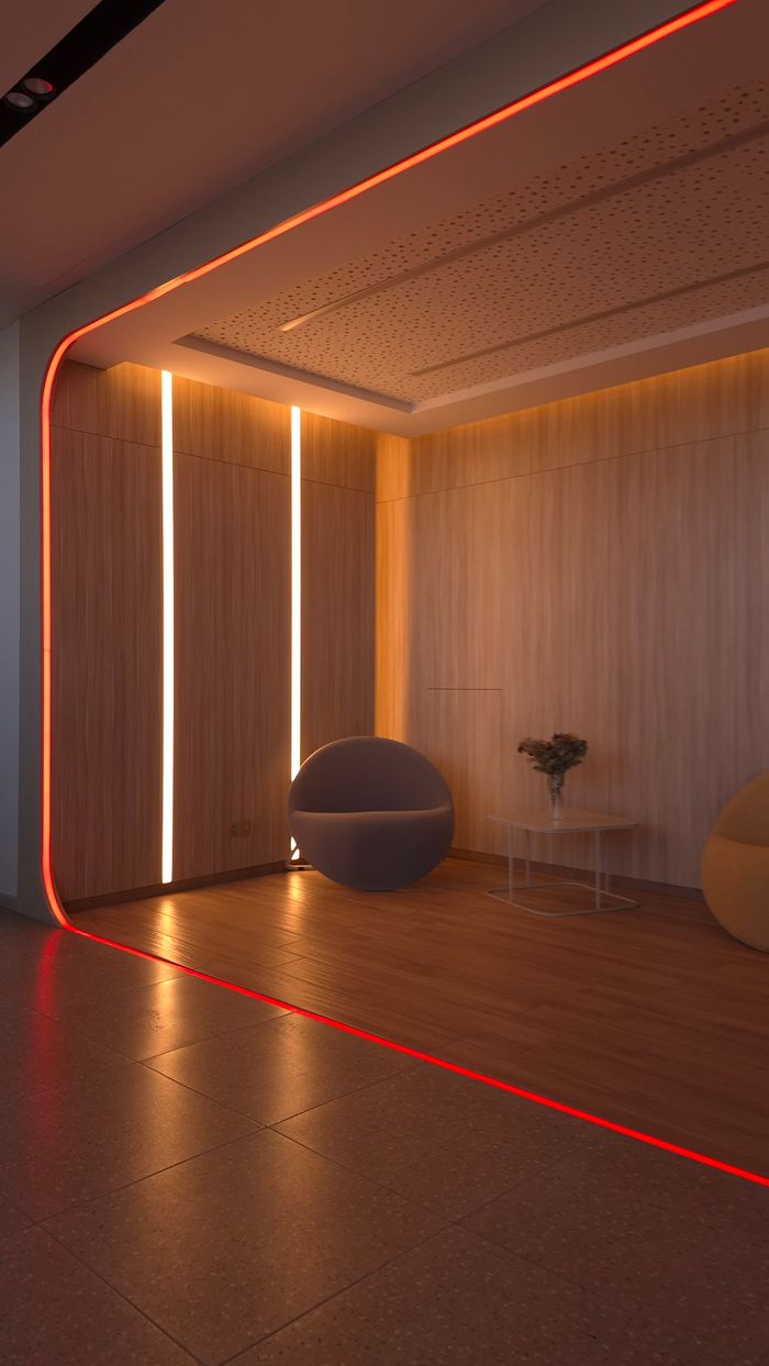 A stylish lobby area featuring ambient lighting and contemporary decor, providing a warm and inviting atmosphere.